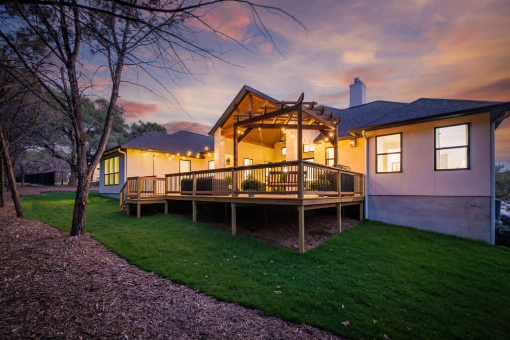 Rear deck and pergola at dusk at the 8179 Blue Oak Way custom home