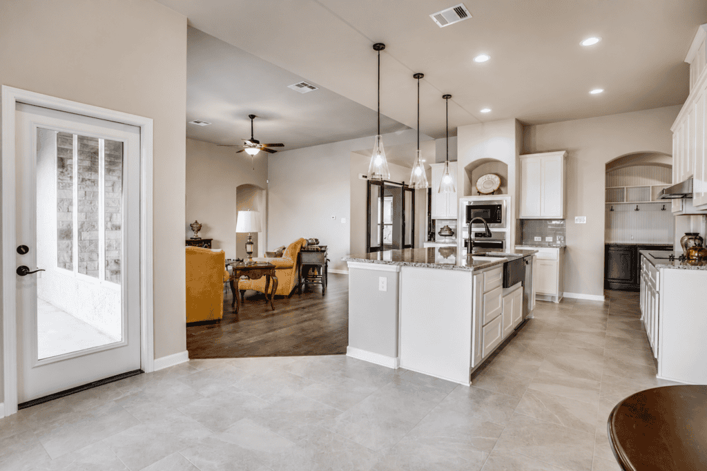 Kitchen and breakfast area with white cabinets in the 1195 Via Principale custom home